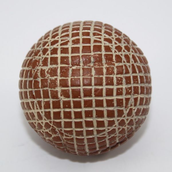 A Red Painted Silvertown Mesh-Patterned Gutty Golf Ball