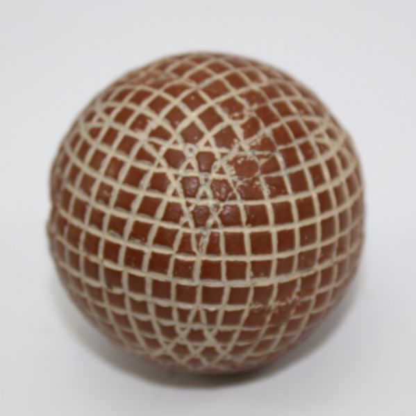 A Red Painted Silvertown Mesh-Patterned Gutty Golf Ball