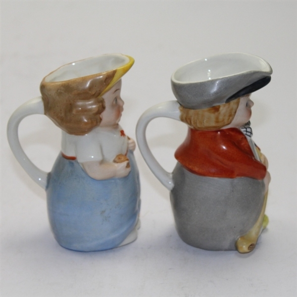 Pair of Ceramic Young Golfers with Pour Spouts and Handles