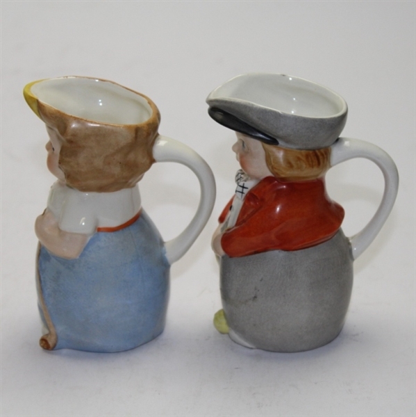 Pair of Ceramic Young Golfers with Pour Spouts and Handles