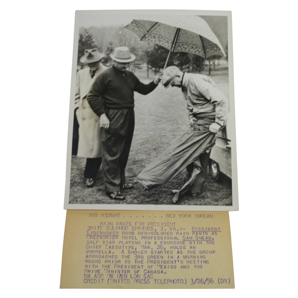 President Eisenhower Putting on Rain Gear with Sam Snead Holding Umbrella 7 1/8x9 Wire Photo