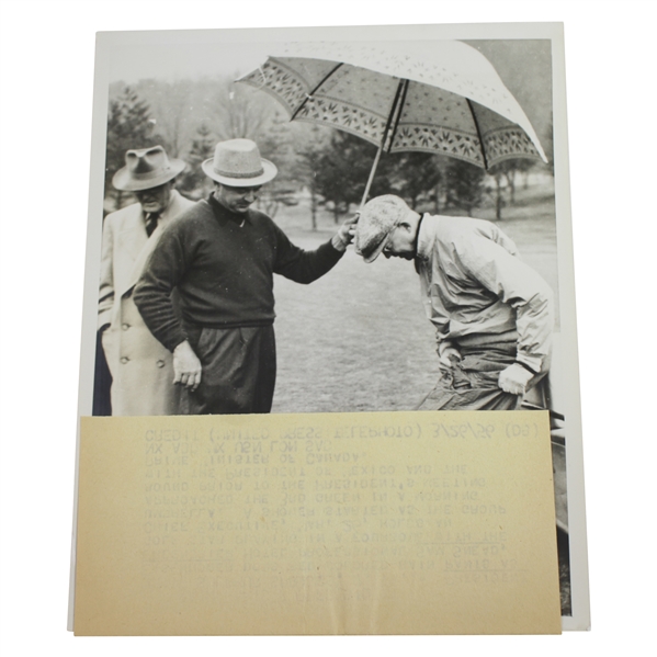 President Eisenhower Putting on Rain Gear with Sam Snead Holding Umbrella 7 1/8x9 Wire Photo